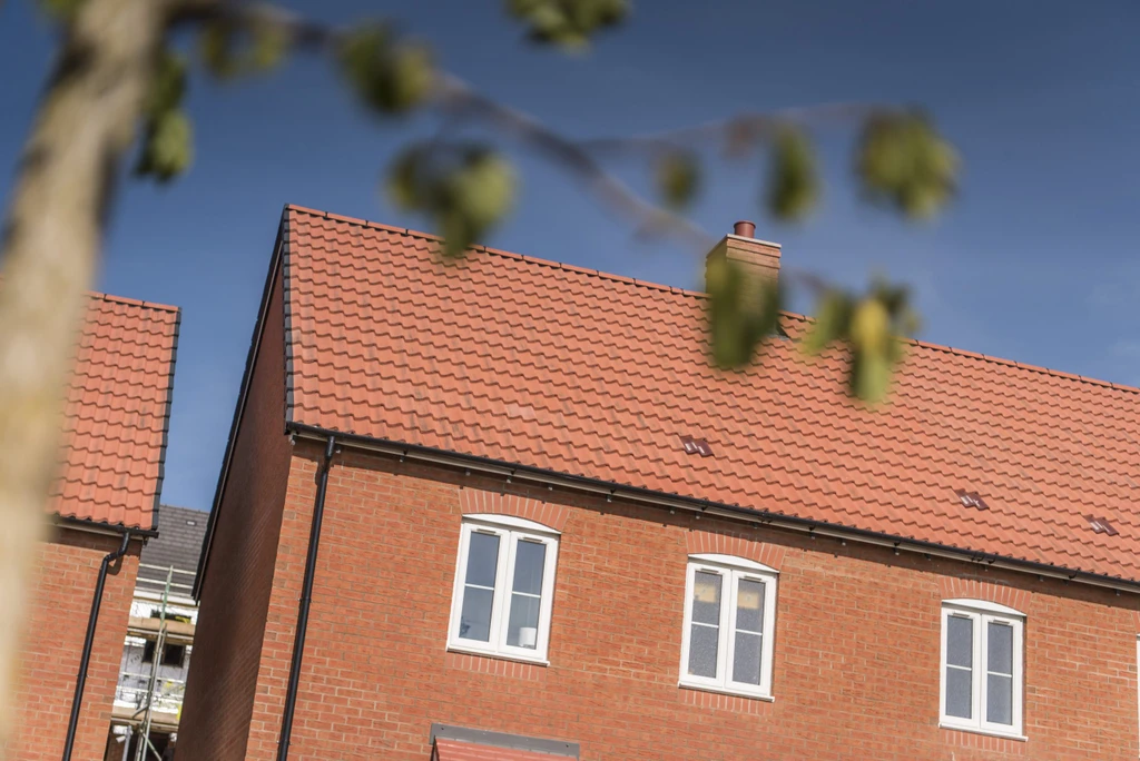 Roof and windows of a newly built house with a background of blue sky