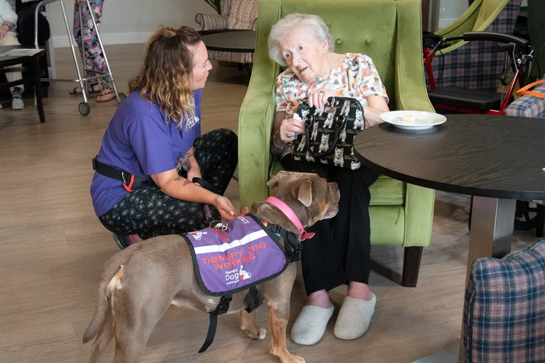 Sally, Pudgy's owner, introduces Pudgy to one of the residents at Chamomile Gardens