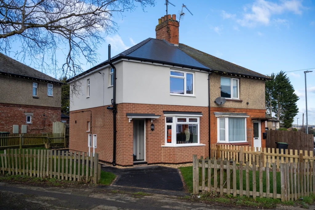 View of two neighbouring houses in Rushden - the one on left has been upgraded and improved