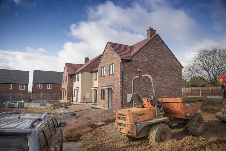 A building site showing new Amplius homes being built