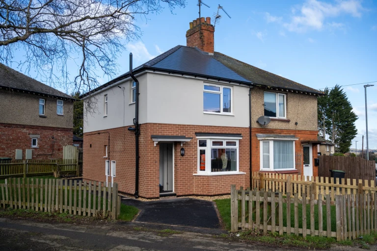 View of two neighbouring houses in Rushden - the one on left has been upgraded and improved