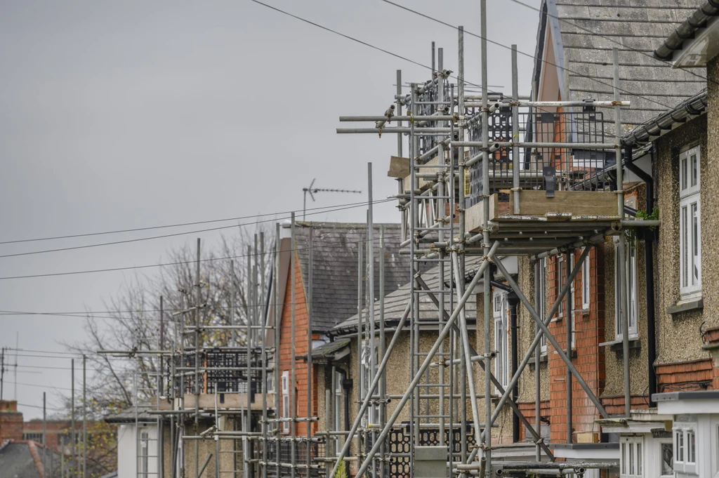 Row of older houses with scaffolding built up around them