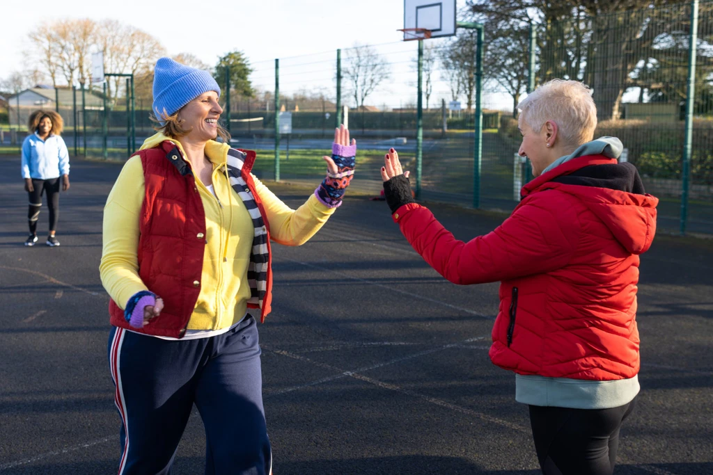 Mature Women High Five at Netball