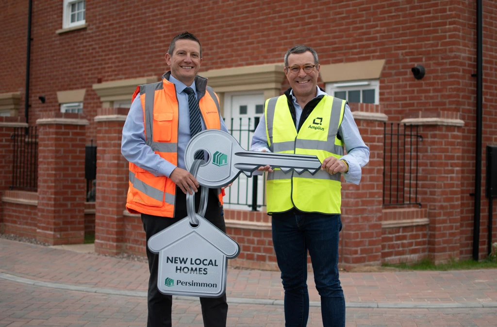 David Ablett, Construction Director at Persimmon Homes, stood alongside Marcus Keys, Chief Development and Commercial Officer at Amplius, outside new homes in The Furlongs, Towcester