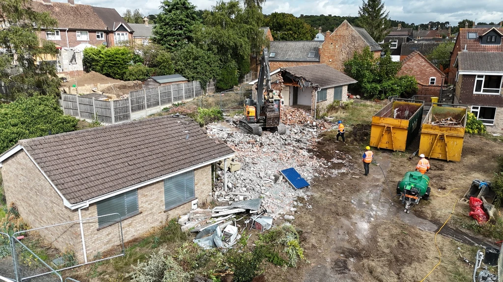 A bulldozer knocking down buildings at Katherine's Gardens in Ampthill