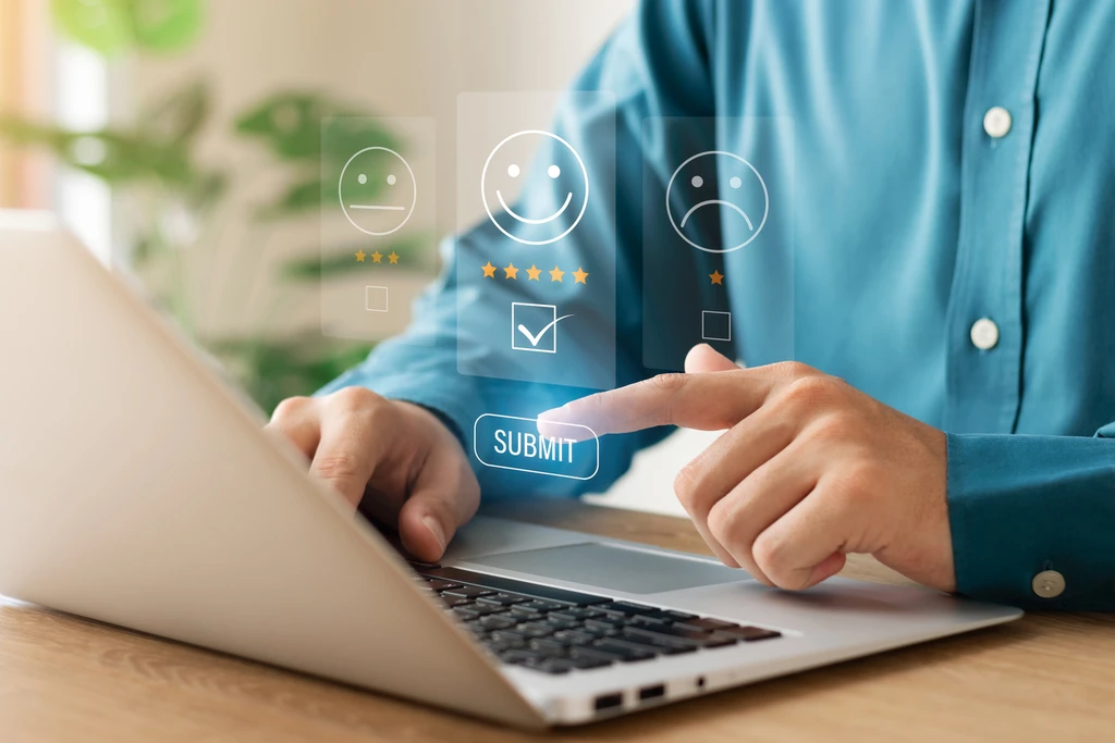 A man completing a satisfaction survey on a laptop