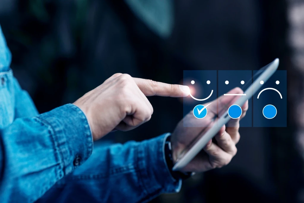 A man's finger pointing to a line drawing of a happy face