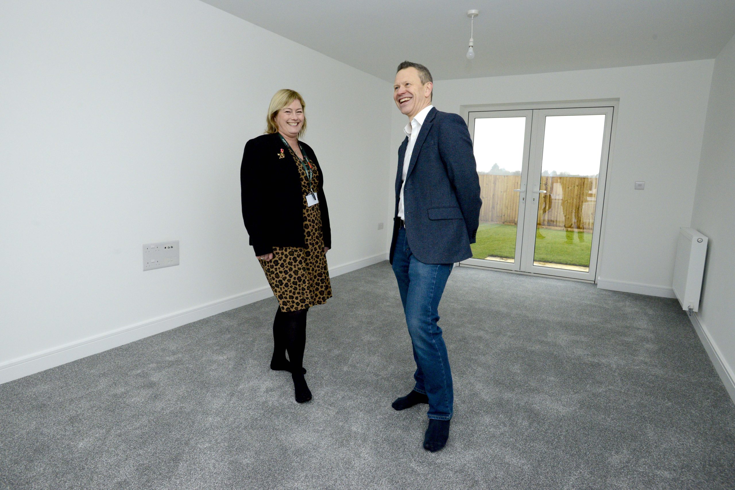 Representatives from Amplius and Allison Homes inside one of the new homes